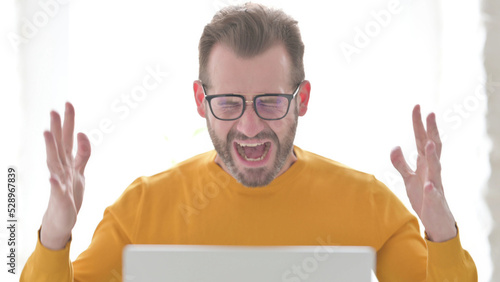 Portrait of Man Shouting while using Laptop