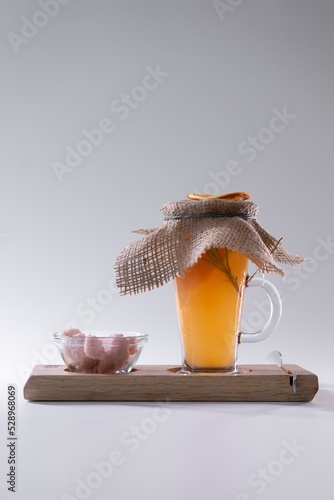 hot fresh orange vitamin grapefruit and rozemary tea cup and pink sugar isolated photo