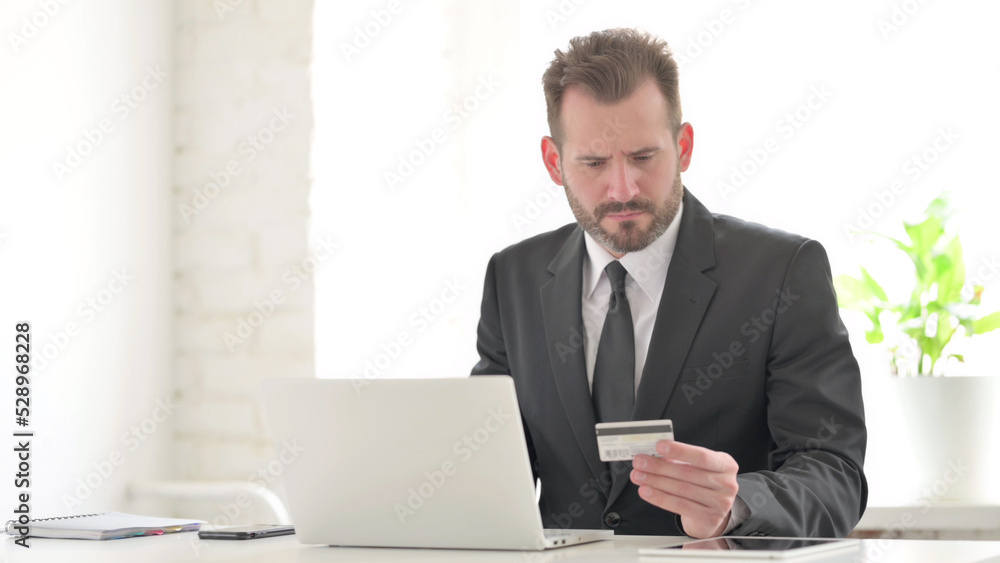 Young Businessman making Online Payment Failure on Laptop in Office Young Businessman making Online Payment Failure on Laptop in Office