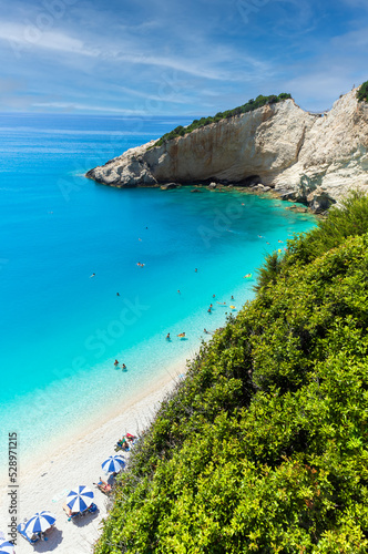 The magnificent Porto Katsiki beach on Lefkada Island, Greece. Beautiful landscape with sea coast, swimming people, trees, azure water.