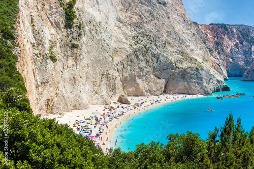 The magnificent Porto Katsiki beach on Lefkada Island, Greece. Beautiful landscape with sea coast, swimming people, trees, azure water.