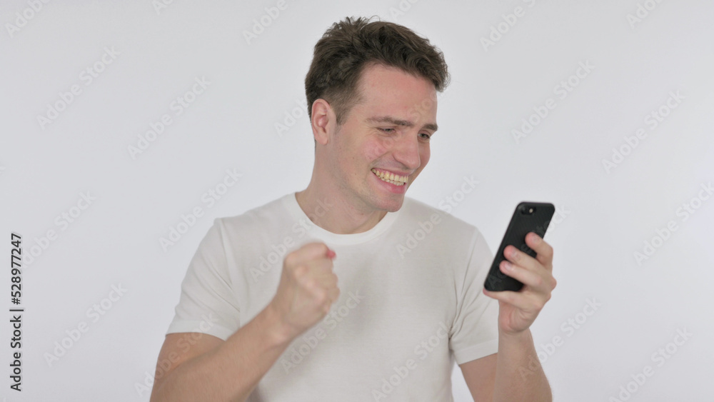 Young Man Celebrating on Smartphone on White Background Young Man Celebrating on Smartphone on White Background