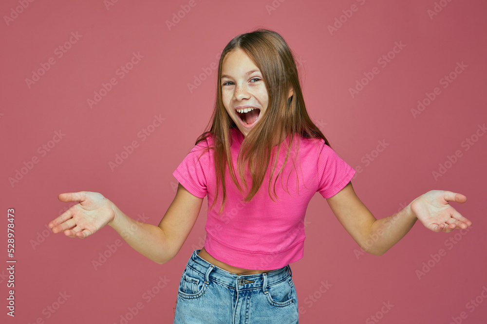 Overjoyed child girl surprised with good news, shouting wow , spreading hands. Children's online store sale Overjoyed child girl surprised with good news, shouting wow , spreading hands. Children's online store sale