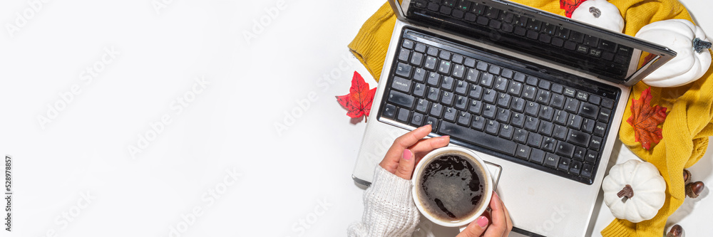 Cozy fall background with coffee cup, tablet notebook, ear-pods, white, orange pumpkins, autumn leaves decor on white home office table background. Autumn still life composition flatlay Cozy fall background with coffee cup, tablet notebook, ear-pods, white, orange pumpkins, autumn leaves decor on white home office table background. Autumn still life composition flatlay