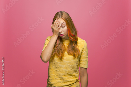 Young girl cover face with hand, do facepalm gesture feeling ashamed of mistake or poor memory. Failure concept