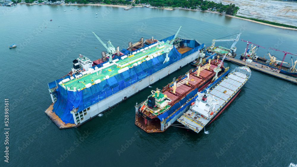 cargo container ship at dry dock concept maintenance service working in the sea. Insurance and Maintenance Cargo Ship concept. Freight Forwarding Service maintenance Insurance