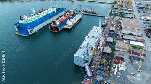 cargo container ship at dry dock concept maintenance service working in the sea. Insurance and Maintenance Cargo Ship concept. Freight Forwarding Service maintenance Insurance © Yellow Boat