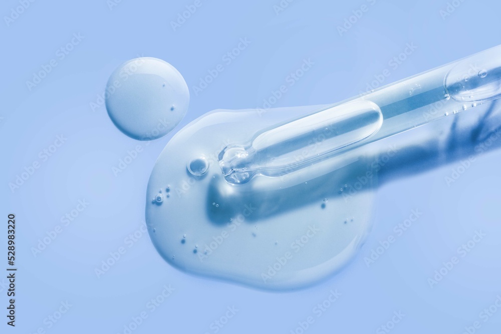 Liquid cool blue gel or serum on blue glass of microscop background Liquid cool blue gel or serum on blue glass of microscop background