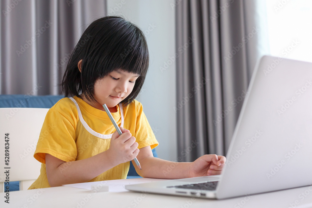 little asian girl student study online using laptop computer at home little asian girl student study online using laptop computer at home