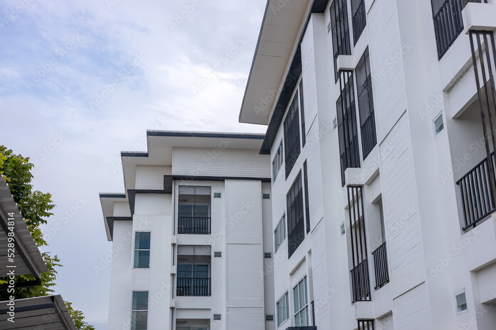 Close-up view of a contemporary rectangular building with many balcony windows of a hotel in Thailand. Close-up view of a contemporary rectangular building with many balcony windows of a hotel in Thailand.