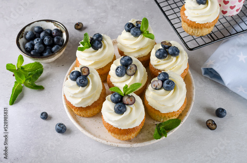 Vanilla cupcakes with blueberries and with cream cheese frosting