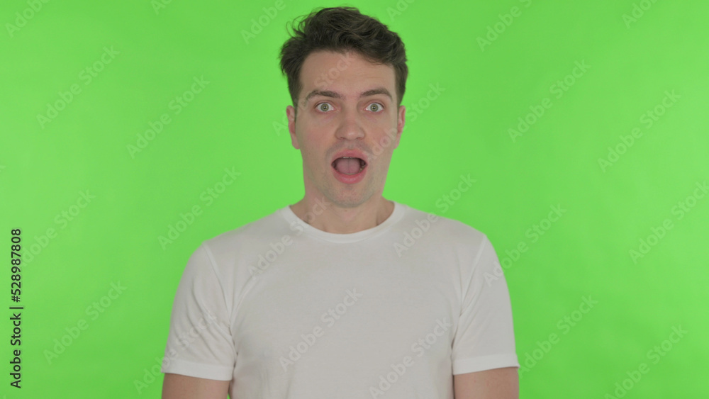 Shocked Young Man Wondering on Green Background Shocked Young Man Wondering on Green Background
