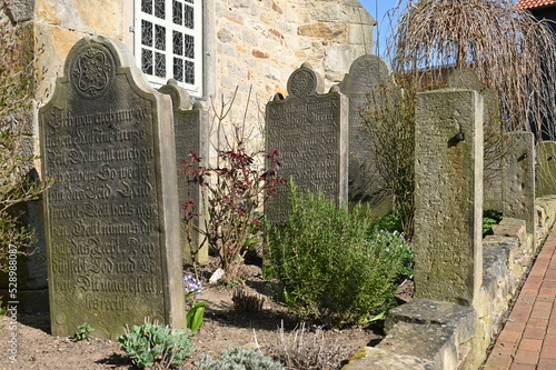 Historische Grabsteine  aus der Mitte des 19. Jahrhunderts vor der Dorfkirche in Heuerssen in Schaumburg photo