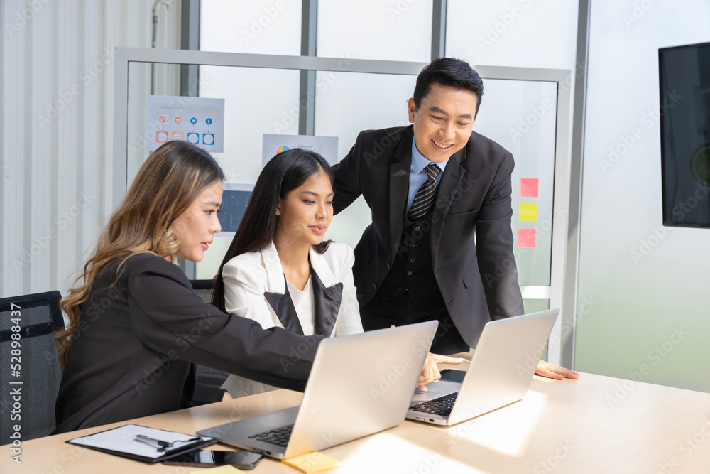 A group of young Asian businessmen Talking and planning work happily and have fun. at the company's office A group of young Asian businessmen Talking and planning work happily and have fun. at the company's office