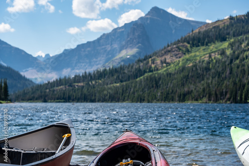 Canoe and kayak on the beach at Two Medicine lake in Glacier National Park.  photo