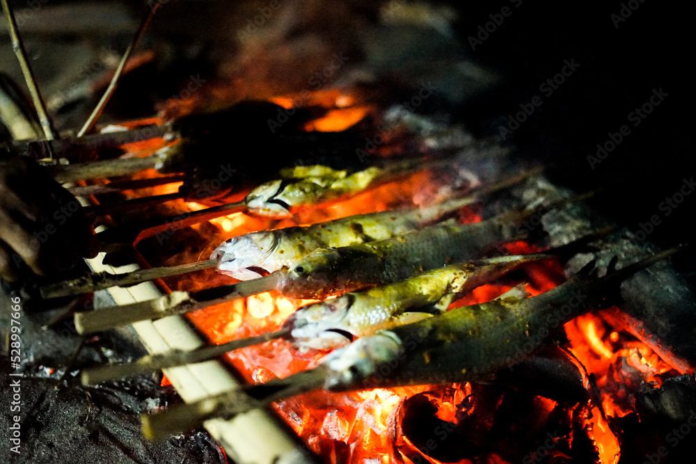 grilled fish cooked on hot coals grilled fish cooked on hot coals