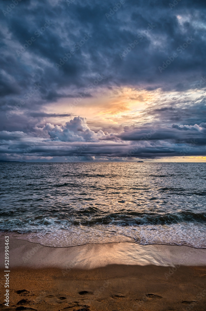 Stormy tropical skies at a beach near Pattaya, Thailand during the monsoon rainy season can produce spectacular sunsets Stormy tropical skies at a beach near Pattaya, Thailand during the monsoon rainy season can produce spectacular sunsets