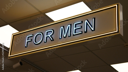 Close-up of a neon sign FOR MEN in a clothing store