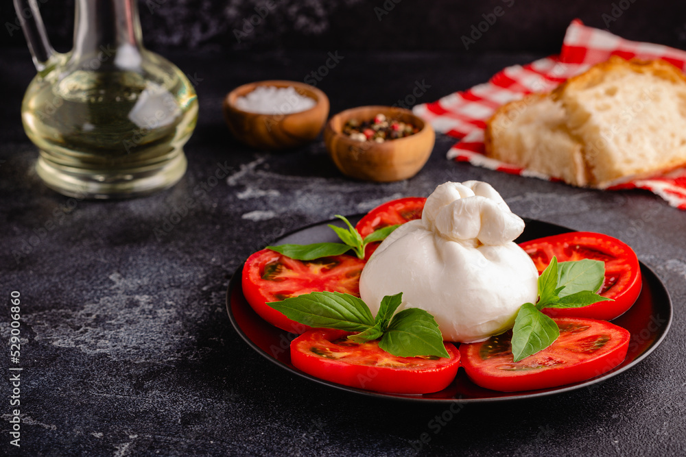 Caprese salad with tomatoes, burrata cheese and basil. Caprese salad with tomatoes, burrata cheese and basil.