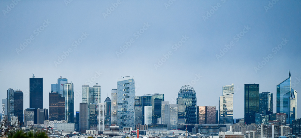 Panoramic view of the skyline of the financial district of La Défense, Paris, France (day time) with a blue sky in the background - obrazy, fototapety, plakaty 