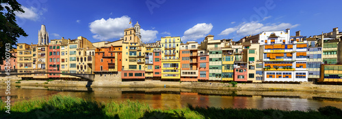 Panoramic view of the picturesque colorful houses next to the Onyar River as it passes through the old city of Girona, Catalonia, Spain.