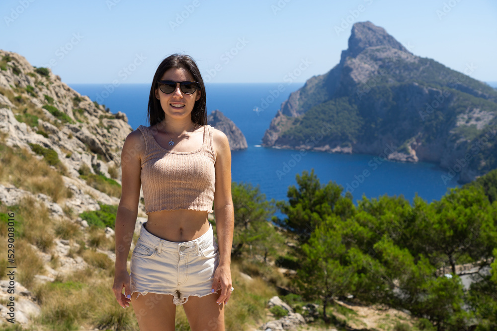 Happy young tourist woman at the viewpoint es Colomer in Mallorca