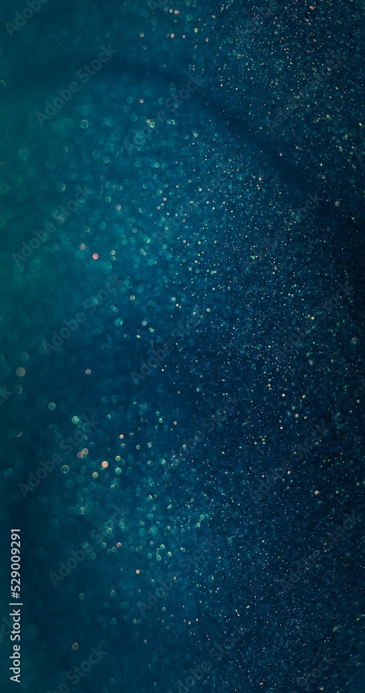 Particles texture background. Blur glitter flare. Bokeh sparkles. Defocused blue orange color shimmering dust on dark abstract overlay.