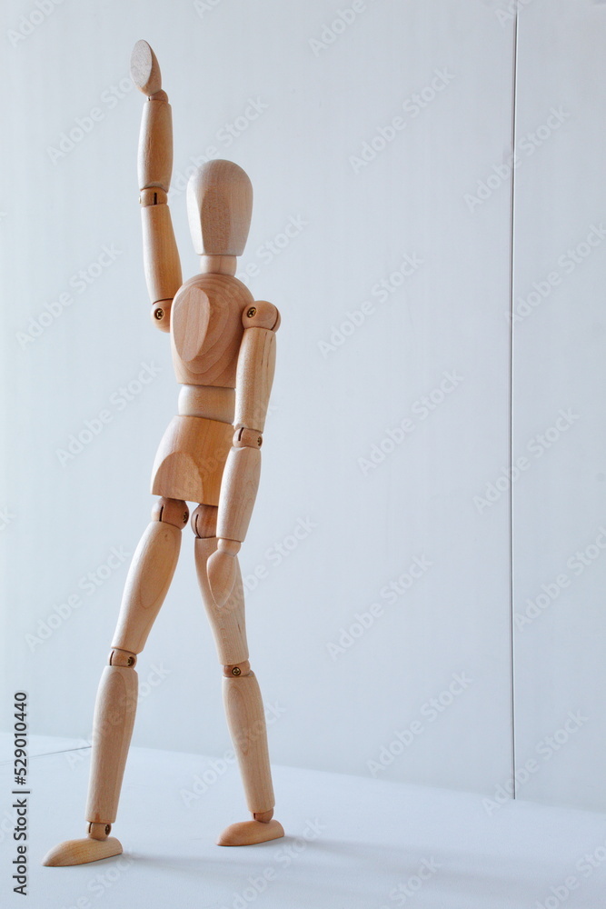 Greeting or leadership concept represented in a wooden doll Greeting or leadership concept represented in a wooden doll