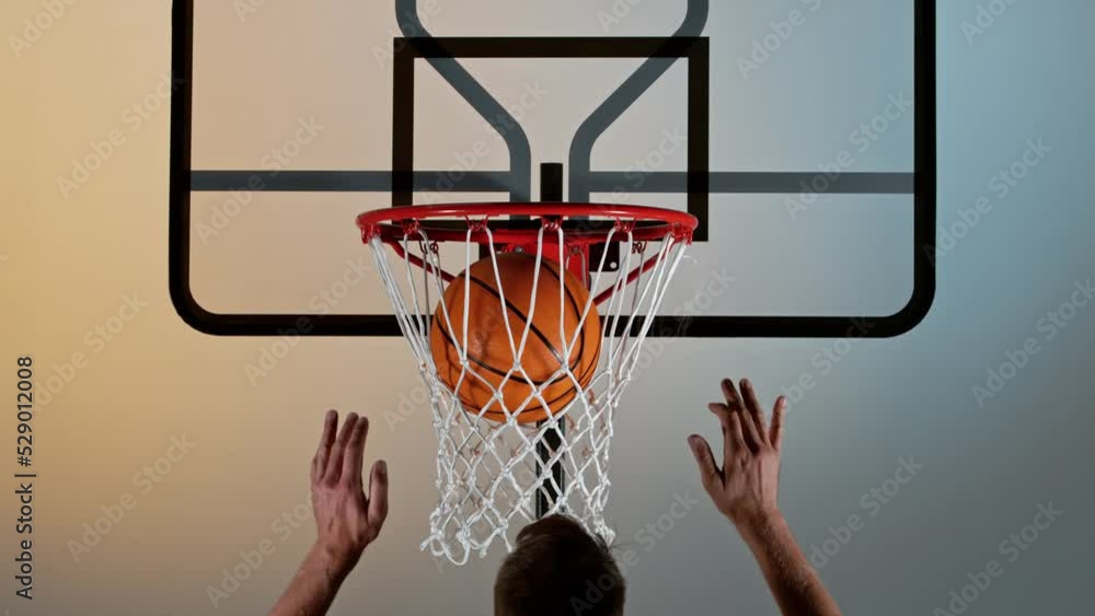 Super slow motion of basketball player running and scoring. Filmed on