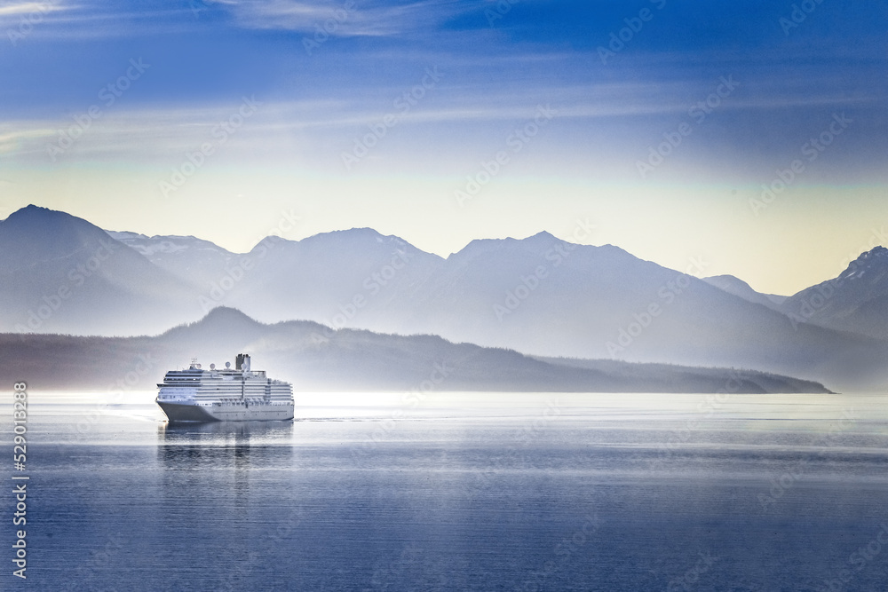 A cruise ship cruising a fjord in Alaska on a summer evening - obrazy, fototapety, plakaty 