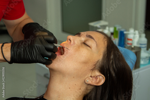dentist puts braces on a woman