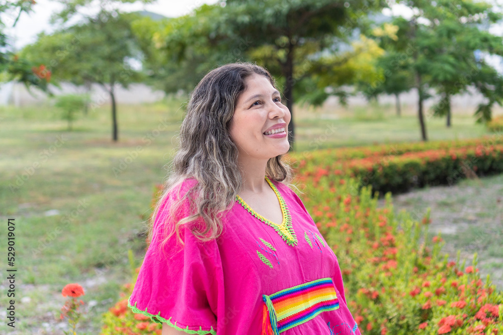 Portrait of young indigenous woman standing in a park Portrait of young indigenous woman standing in a park
