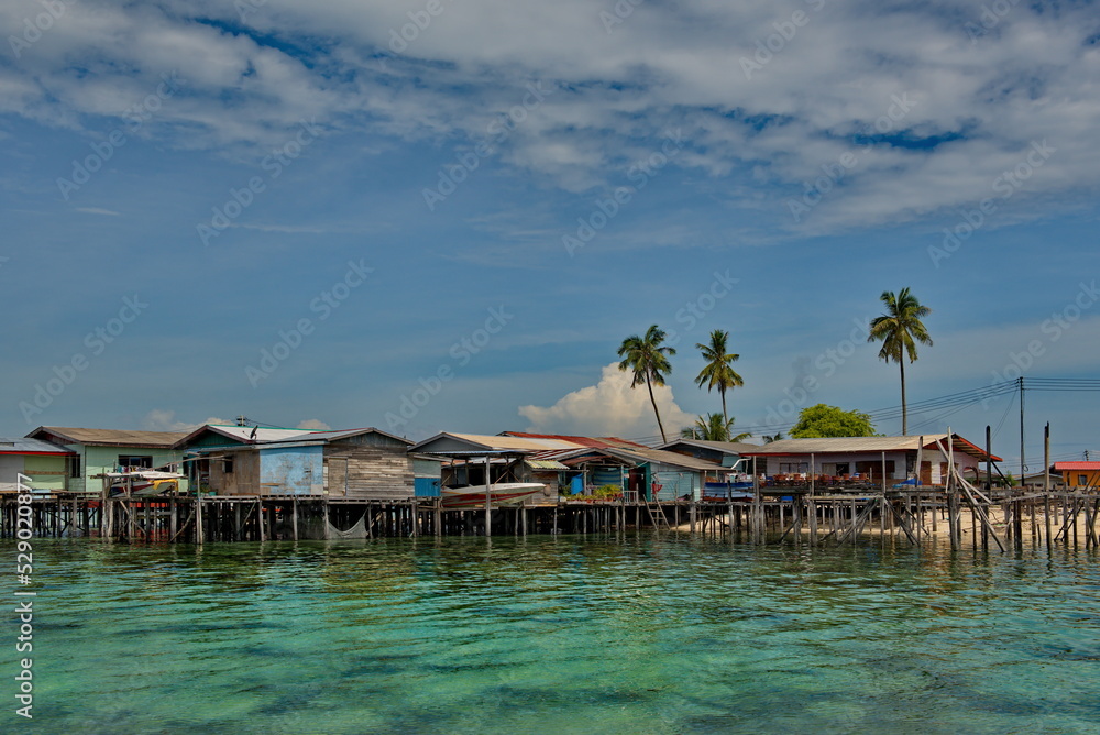 Island of Borneo. Malaysia. December 01, 2018. Sea Gypsy village on a sandy coral reef island. The main trade of local residents is fishing and sea Souvenirs.
