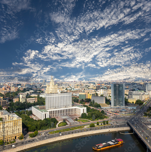 Aerial view of Moscow against the background of the sky with clouds. Government House of the Russian Federation (White House)-written in Russian, Russia