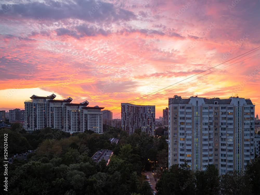 Residential area of Moscow (against the background of a romantic evening sky with clouds and rays of the sun), Russia