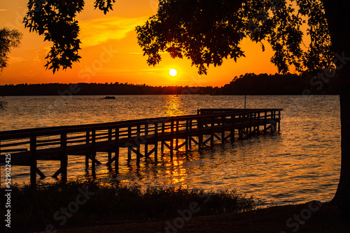 Orange sunset over water photo