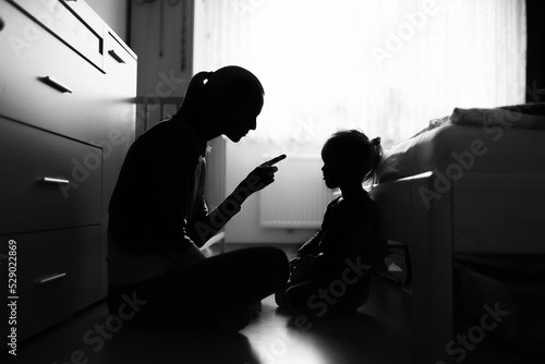 Mother correcting, disciplining her child for bad behavior	
