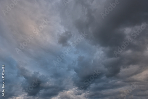 Russia. The South of Eastern Siberia. Gloomy sunset clouds in the evening summer sky over the mountain ranges of Eastern Sayan.