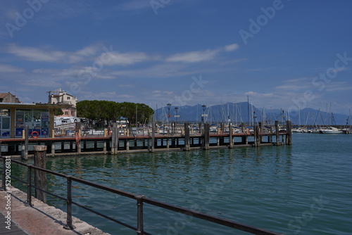 Desenzano del Garda, Italy - July 12, 2022 - yachts and boats docked at the port on Lake Garda on a sunny summer morning