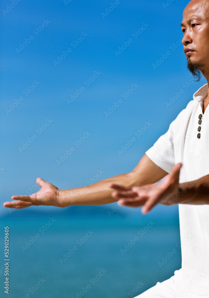 Man Practices Qi Gong at sunrise. Koh Samui, Thailand. Man Practices Qi Gong at sunrise. Koh Samui, Thailand.