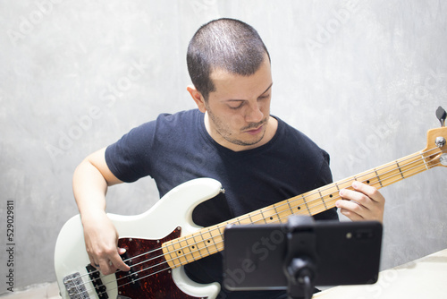 Bass teacher/student in video class on cellphone.