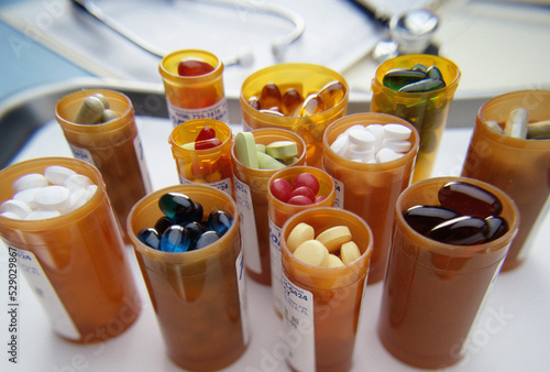 Close-up of an assortment of tablets and capsules in vials photo