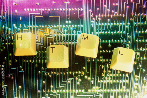 Close-up of key spelling HTML on a circuit board photo