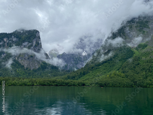 Lake with mountain panorama and fog in the background