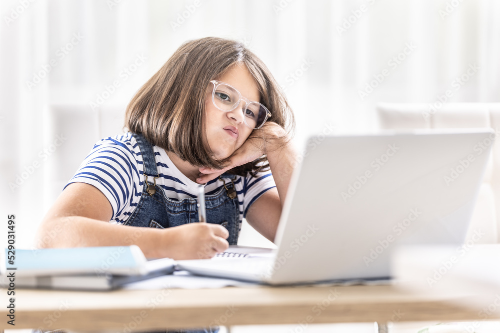 Distance learning not fitting the mood of a young schoolgirl studying from home Distance learning not fitting the mood of a young schoolgirl studying from home
