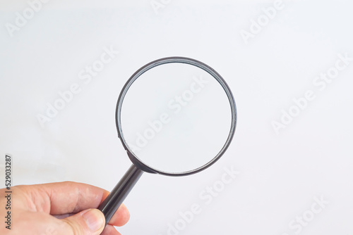 hand holding magnifying glass Detective and Search Idea Concept.