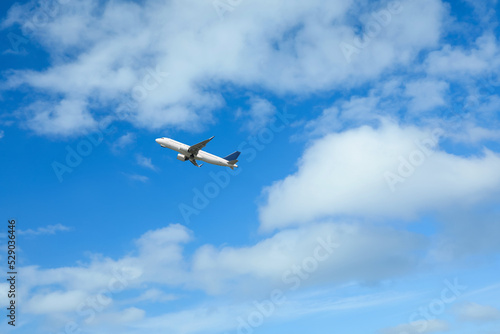 Beautiful view of modern airplane in blue sky. Space for text