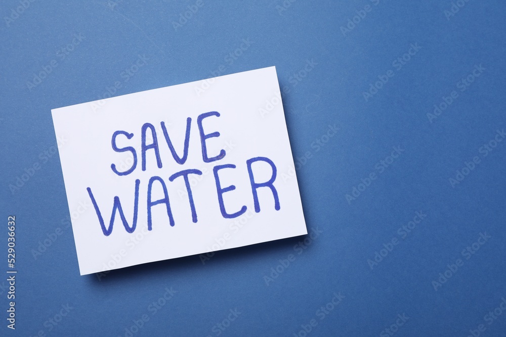 Card with words Save Water on blue background, top view. Space for text Card with words Save Water on blue background, top view. Space for text