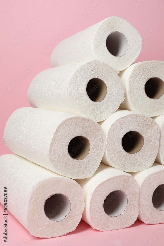 Many rolls of paper towels on pink background Many rolls of paper towels on pink background