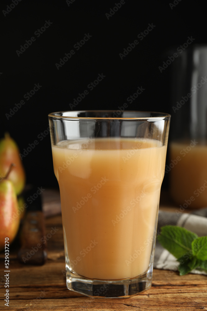 Fresh pear juice in glass on wooden table, closeup Fresh pear juice in glass on wooden table, closeup